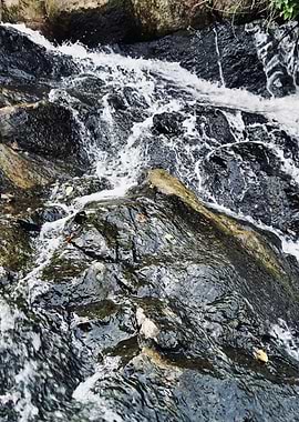 Water Flowing Over Dark Rock