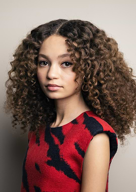 Portrait of young woman with curly hair nico parker