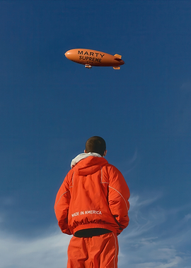 Man Gazing at 'Marty Supreme' Blimp