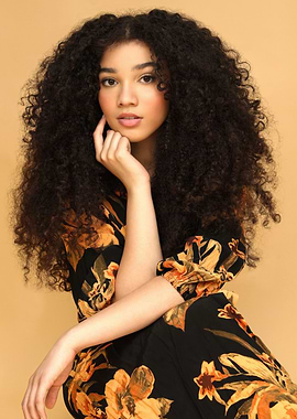 Portrait of a woman with curly hair malia baker