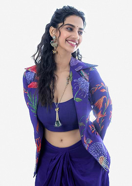 meenaakshi Smiling Woman in Blue Floral Outfit