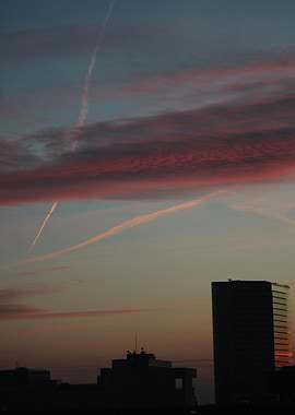 Cityscape at Dusk with Contrails