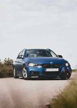 Blue BMW Wagon on Rural Road