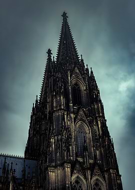 Cologne Cathedral Spire Under Cloudy Sky