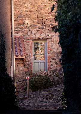 Stone Building with Doorway and Cobblestone Path