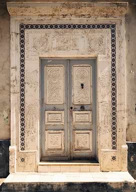 Ornate weathered door with tile border, Tunisia