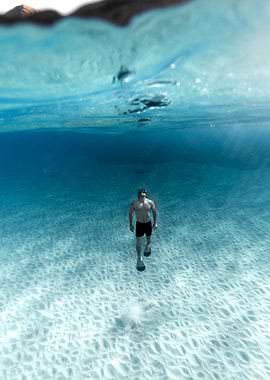 Man snorkeling in clear turquoise water