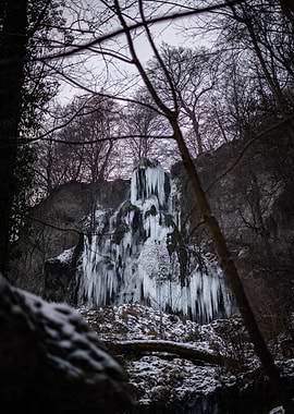 Frozen Waterfall in Winter Forest