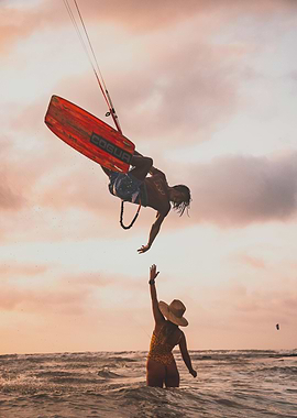 Kitesurfer Jumping Over Woman in Ocean