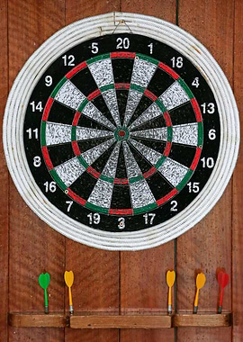 Dartboard with Darts on Wooden Wall