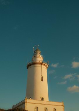 White Lighthouse Against a Blue Sky