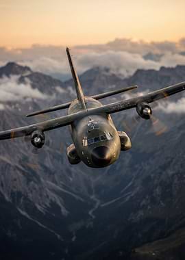 Military transport plane flying over mountains
