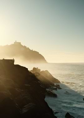 Coastal Sunset with Rocks and Waves