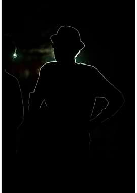 Silhouetted Figures in Dark Setting