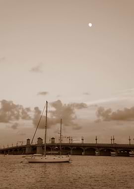 Sepia Sailboat Under Bridge at Night