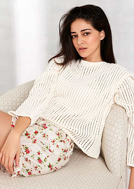 Woman in Cream Sweater and Floral Shorts