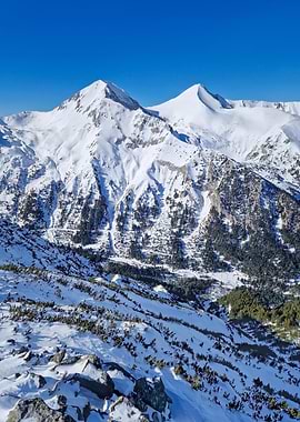 Snowy Mountain Peaks Under Clear Blue Sky