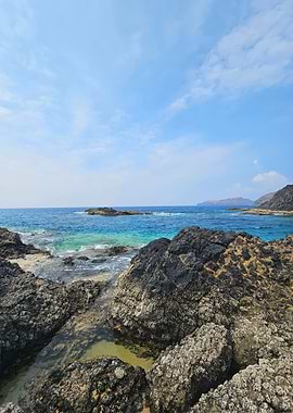 Turquoise Tides Over Volcanic Rock