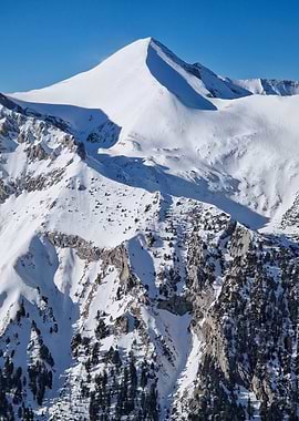 Snowy Mountain Peak Under Blue Sky
