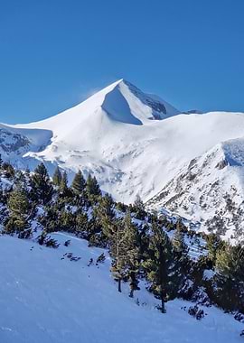 Snowy Mountain Peak Under Blue Sky