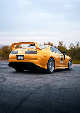 Yellow Toyota Supra on Asphalt