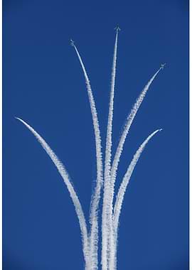 Airplanes performing aerobatics in blue sky