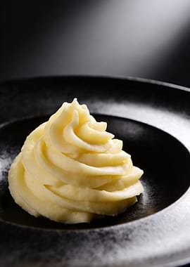 Mashed potatoes on black plate