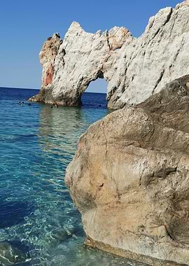 Rock Archway on a Clear Blue Sea