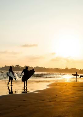 Surfers at Sunset on a Beach