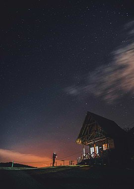 Cabin under the starry night sky