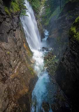 Waterfall cascading through rocky gorge