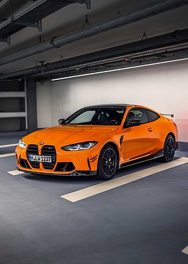 Orange BMW M4 parked indoors