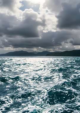 Ocean waves under a cloudy sky