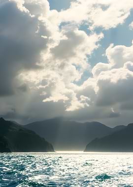 Dramatic seascape with mountains and clouds