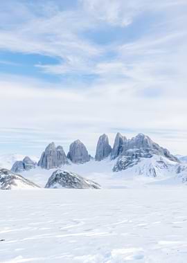 Snowy Mountain Peaks Under Cloudy Sky