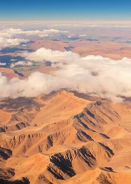 Aerial view of desert mountains and clouds