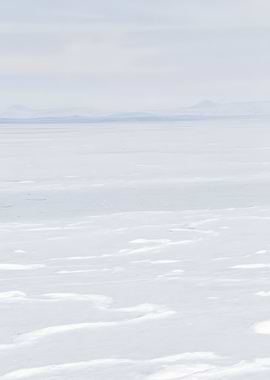 Snowy landscape with distant mountains