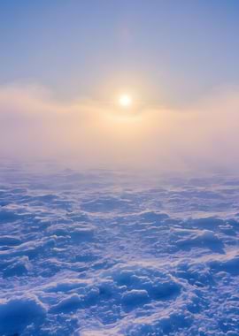 Snowy landscape with sun and fog