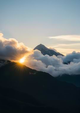 Mountain Peak Sunrise Through Clouds