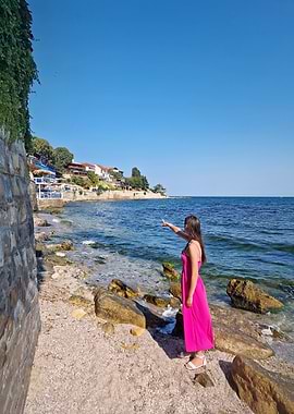 Woman in Pink Dress by Seaside