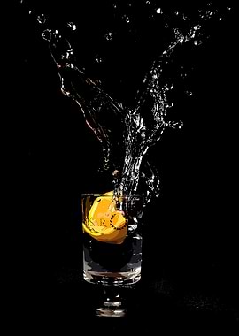 Orange slice splashing into a glass