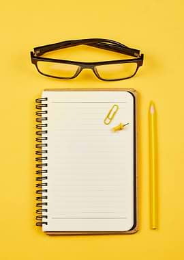 Desk supplies on yellow background