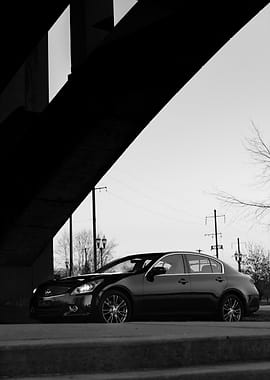 Infiniti Black Sedan Under Bridge