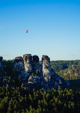 Hot Air Balloon Over Rocky Peaks
