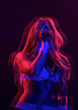 Singer performing under red and blue lights