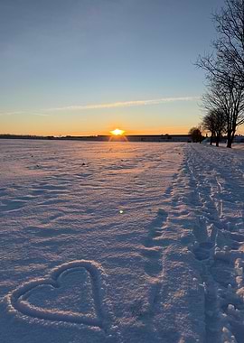 Winter wonderland with heart in the Snow at Sunset