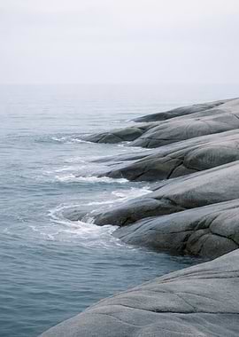 Ocean waves crashing on rocky shore
