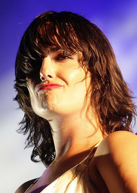 kosheen with dark hair and red lipstick