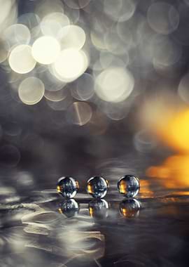 Three Glass Marbles on Reflective Surface