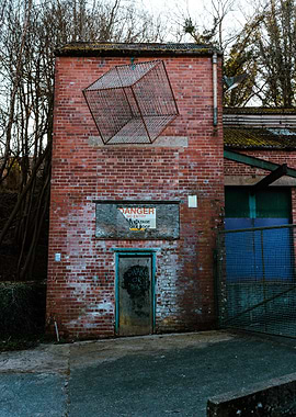 Abandoned Brick Building with Wire Cube Art